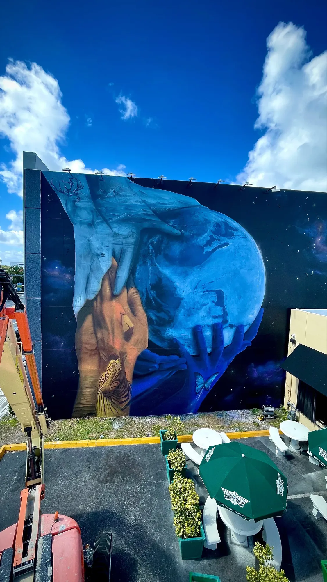 Holding Tomorrow — mural by Carmo (Fabio Onrack) in North Miami, FL